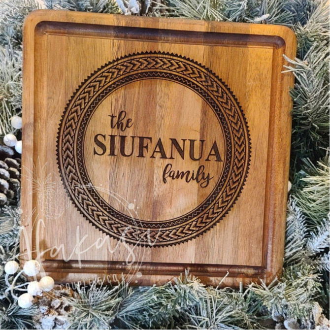 Laser engraved Polynesian tattoo circle design on a wooden cutting board.
